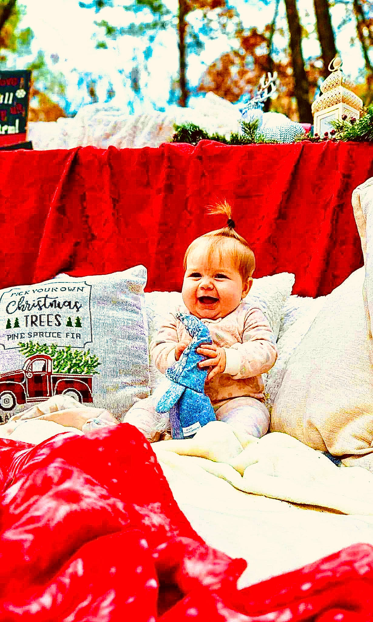 Indie is registered to the contest to win money with this photo: baby, baby_toddler_clothing, bedding, carmine, child, comfort, event, fictional_character, happy, linens, magenta, people_in_nature, person, pillow, red, room, smile, textile, throw_pillow, toddler