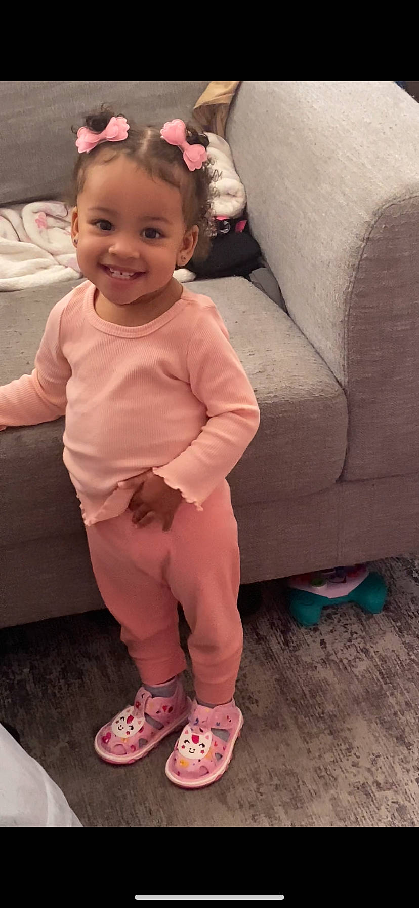 bodypart, child, clothing, couch, face, female, finger, footwear, furniture, girl, hand, happy, head, person, photography, portrait, shoe, sitting, smile, sneaker