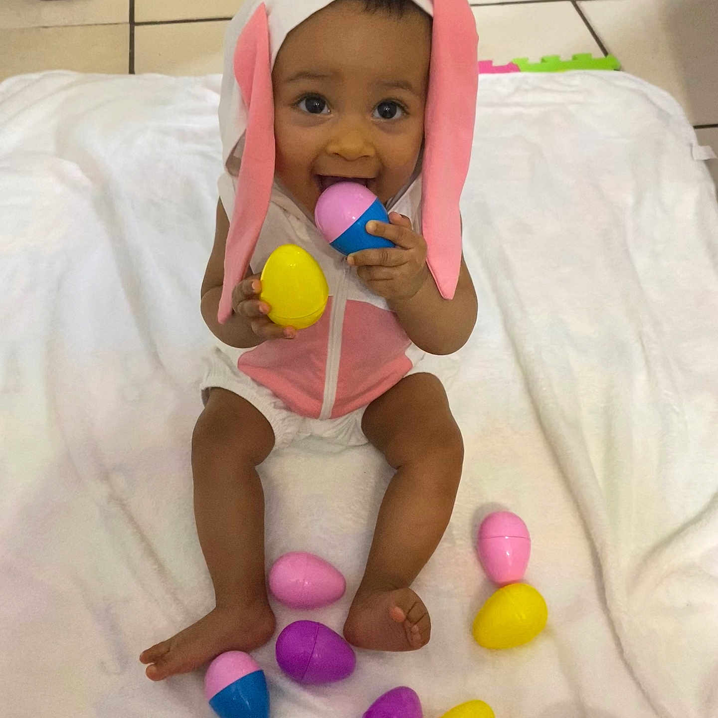 Jade is registered to the contest to win money with this photo: baby, balloon, bed, blanket, bodypart, clothing, cutlery, face, finger, food, furniture, hat, head, person, photography, portrait, purple, sitting, spoon, sweets