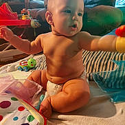 Alexander joined the competition — help win amazing prizes! baby, diaper, toy, indoor, child, cute, sitting, blanket, colorful, playtime, soft_light, living_room, furniture, couch, curious, infant, skin, person, floor, comfort