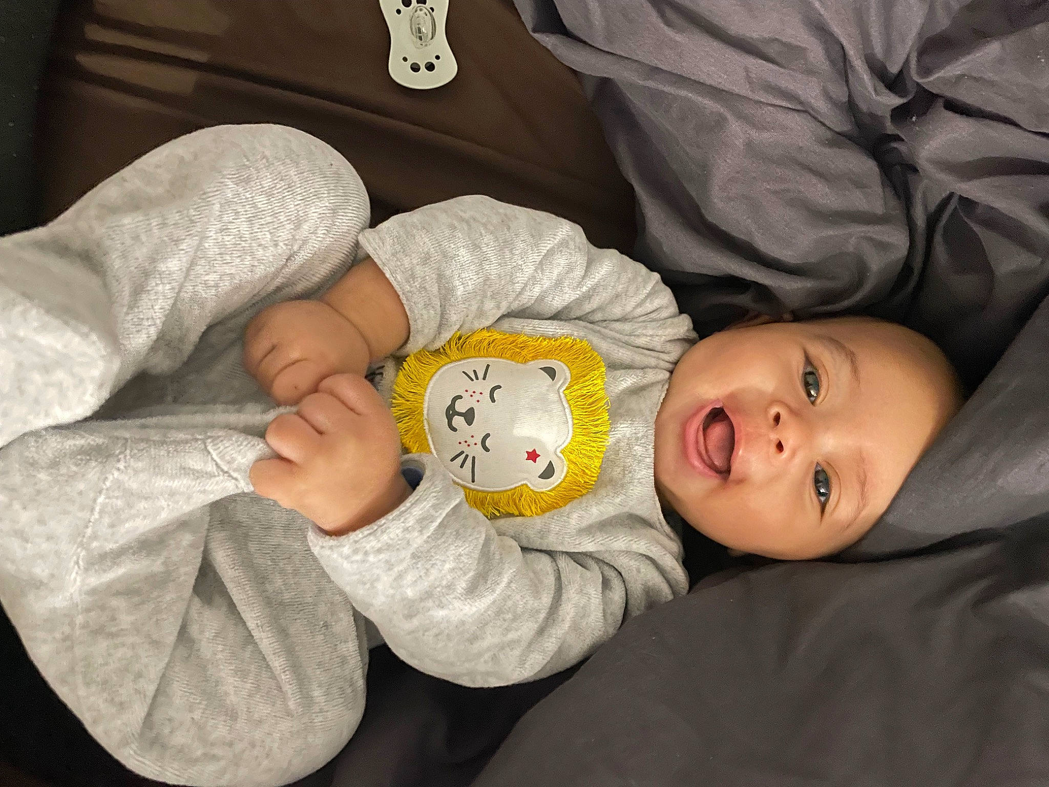 Ezra a rejoint le concours — aidez-le/la à gagner de superbes lots ! baby, baby_toddler_clothing, cheek, child, comfort, facial_expression, fun, gesture, happy, headwear, linens, mouth, person, room, sitting, sleeve, smile, toddler