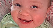 Bella joined the competition — help win amazing prizes! baby, smiling, face, child, infant, happy, portrait, cute, eyes, clothing, green_shirt, cheeks, mouth, teeth, skin, head, person, indoors, pattern, background