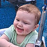 Bella joined the competition — help win amazing prizes! baby, child, smiling, swing, playground, happy, infant, cute, hands, face, outdoor, seat, metal, clothing, green_shirt, person, cheeks, joyful, toy, fun