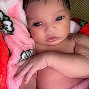 Vie Vie is registered to the contest to win money with this photo: baby, infant, blanket, pink, red, couch, face, hand, skin, portrait, cute, newborn, cozy, soft, child, young, wrapped, indoors, expression, resting