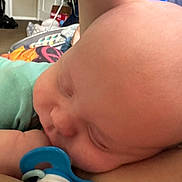 Mac joined the competition — help win amazing prizes! baby, sleeping, pacifier, close_up, infant, head, skin, child, indoors, resting, peaceful, cute, small, wearing, clothing, person, human, relaxing, face, newborn