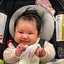 baby, smiling, car_seat, blanket, infant, child, happy, face, clothing, seatbelt, toddler, indoors, cute, headrest, safety, soft_toy, warm, portrait, person, hair