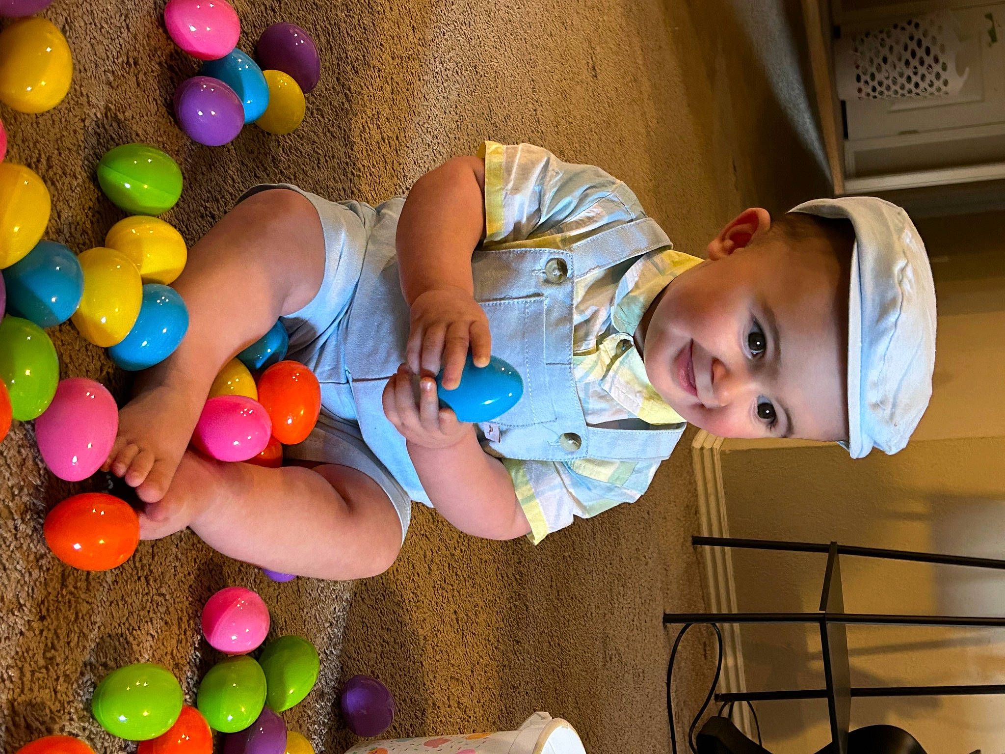 Chrystian is registered to the contest to win money with this photo: baby, baby_products, baby_toddler_clothing, balloon, child, easter, event, fun, happy, hat, headwear, leisure, party, party_supply, person, play, product, room, sitting, smile
