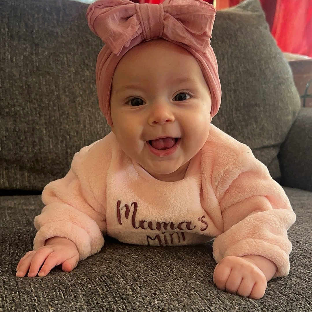 Laiken joined the competition — help win amazing prizes! architecture, baby, building, cap, clothing, couch, cushion, face, furniture, happy, hat, head, homedecor, indoors, livingroom, person, photography, portrait, room, sitting