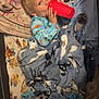 child, pajamas, blanket, cup, stuffed_animal, monkey, bedtime, sleeping_area, cozy, indoor, smiling, comfort, soft_toys, colorful, bed, resting, drink, young_child, happy, relaxing