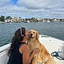 Vega joined the competition — help win amazing prizes! woman, dog, golden_retriever, boat, water, sky, clouds, houses, kiss, hug, smile, outdoor, pet, leisure, summer, nature, vacation, rope, water_bottle, long_hair