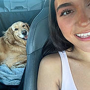 Vega joined the competition — help win amazing prizes! woman, dog, golden_retriever, car, seat, smile, face, hair, pet, leisure, happy, indoor, shoulder, tank_top, fur, animal, relaxation, comfort, friendship, travel