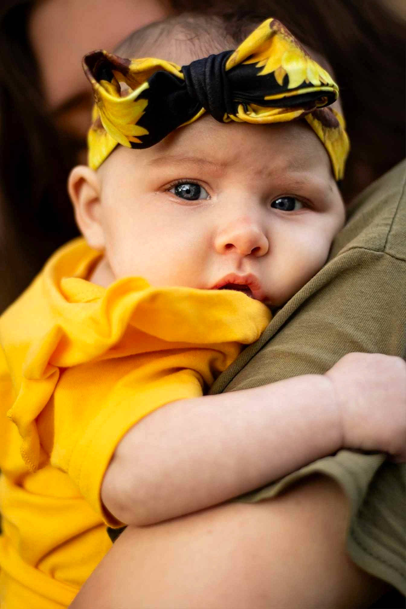 Elaina joined the competition — help win amazing prizes! baby, baby_toddler_clothing, cap, cheek, chin, costume_hat, eye, eyebrow, finger, fun, gesture, grass, happy, hat, head, headgear, headwear, iris, person, personal_protective_equipment