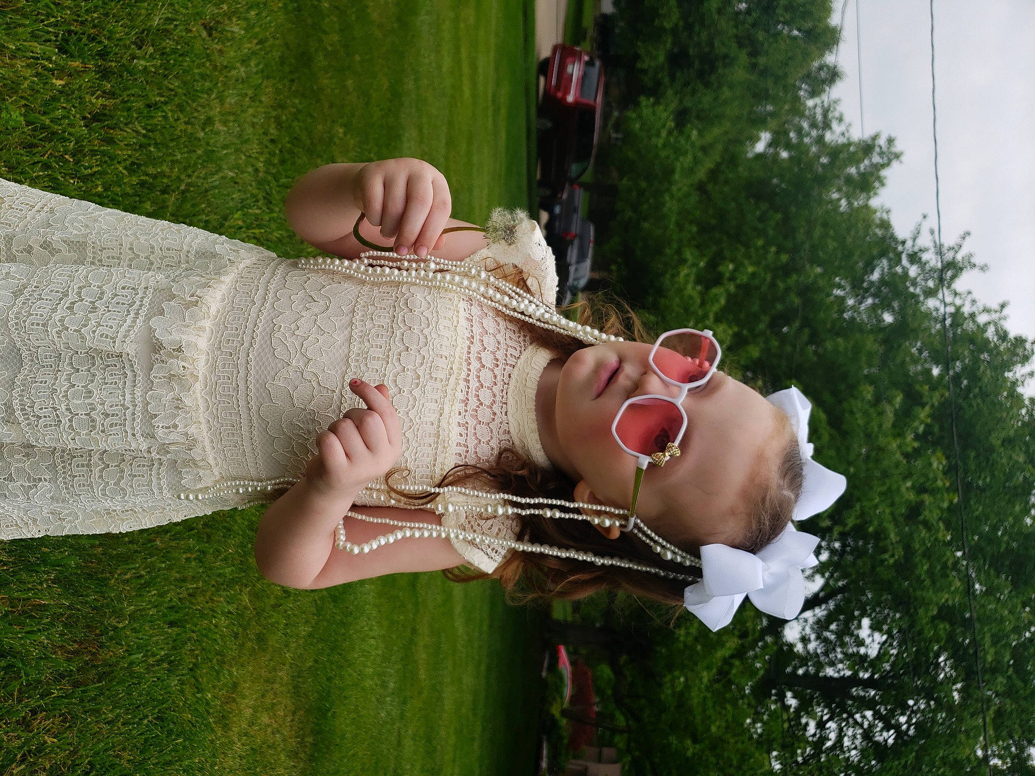 Armani is registered to the contest to win money with this photo: baby, event, eyewear, finger, fun, gesture, grass, happy, jewellery, leisure, necklace, people_in_nature, person, plant, recreation, smile, spring, thumb, tree, vegetable