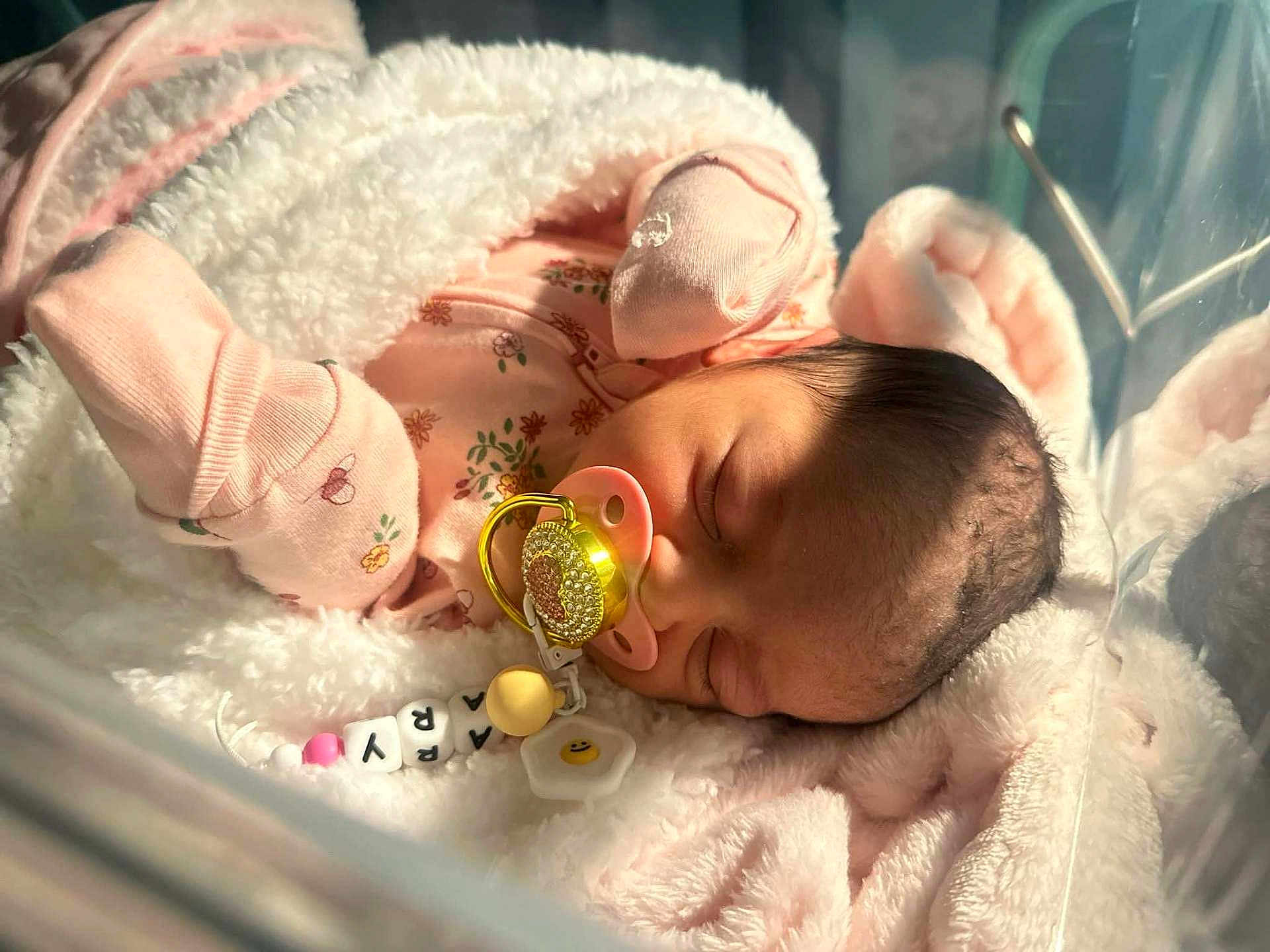 Arya is registered to the contest to win money with this photo: newborn, baby, sleeping, blanket, pacifier, crib, infant, pink, clothing, cute, face, rest, soft, cozy, indoors, child, person, peaceful, hair, skin