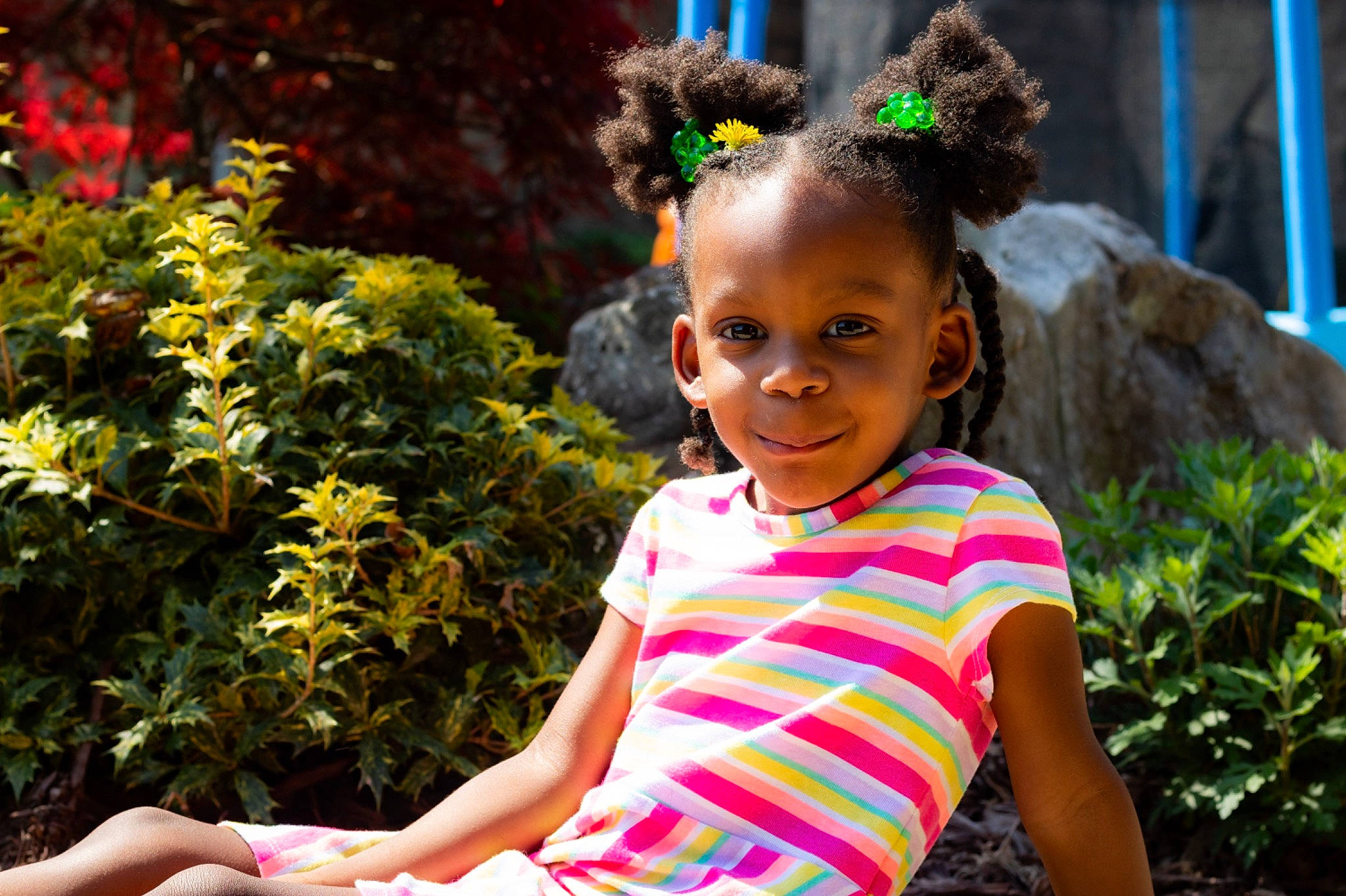 Giselle is registered to the contest to win money with this photo: adaptation, botany, child, facial_expression, fun, hair, hair_accessory, hairstyle, happy, human, joy, leaf, organism, people, person, pink, plant, play, smile, summer
