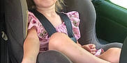 Shaylynn Brannan joined the competition — help win amazing prizes! child, toddler, car_seat, seatbelt, pink_dress, smiling, blond_hair, car_interior, window, green_background, sitting, reaching_hand, young_girl, portrait, safety, child_safety, casual, daylight, happy, vehicle