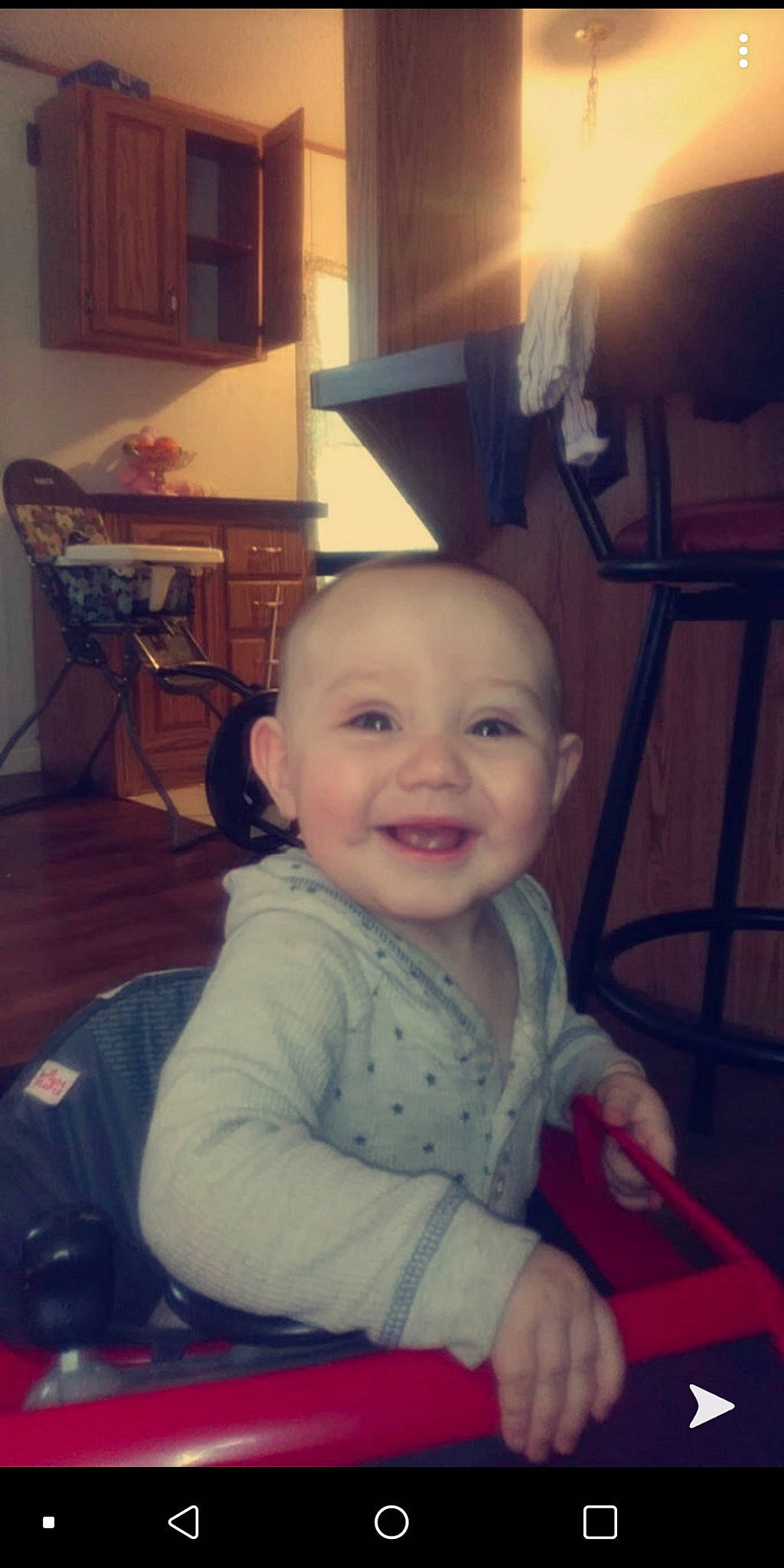 Jupiter is registered to the contest to win money with this photo: baby, cheek, child, chin, ear, electronic_device, eye, face, facial_expression, forehead, fun, head, iris, joy, people, person, sitting, skin, smile, toddler