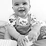 baby, black_and_white, candid, child, clothing, cute, face, feet, hands, happy, indoor, infant, mickey_mouse, overalls, playful, portrait, shirt, shoes, sitting, smiling