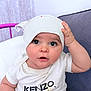 baby, child, closeup, clothing, couch, curious_expression, cute, face, hand_on_head, indoor, infant, kenzo_tshirt, portrait, purple_cushion, short_sleeves, sitting, skin, soft_lighting, toddler, white_hat