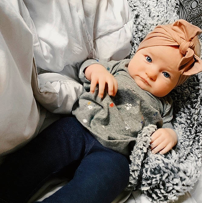 Brinley is registered to the contest to win money with this photo: arm, baby, birth, child, comfort, doll, ear, figurine, hand, head, human, joint, person, sitting, toddler, toy