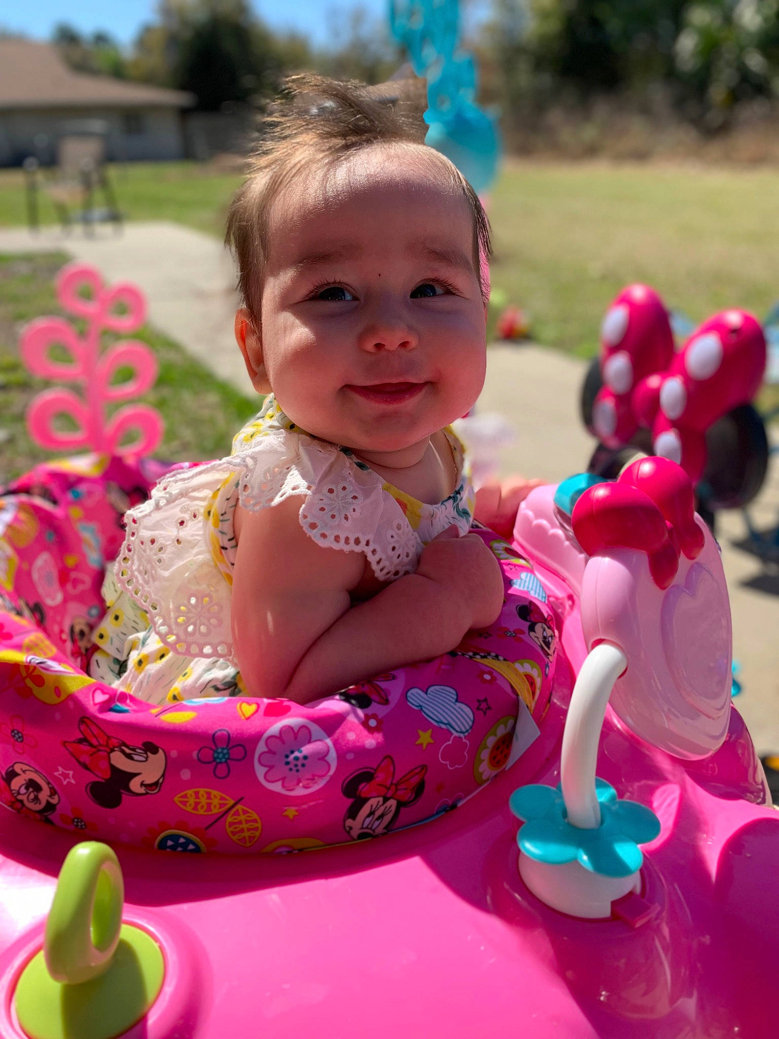 Annalise is registered to the contest to win money with this photo: baby, baby_playing_with_toys, baby_toddler_clothing, child, event, face, facial_expression, fun, grass, hairstyle, happy, head, leisure, person, pink, plant, recreation, skin, smile, snapshot
