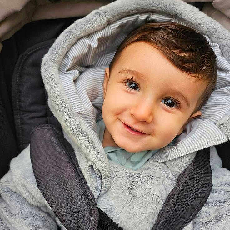 Elijah-Jabran is registered to the contest to win money with this photo: baby, baby_boy, car_seat, child, closeup, clothing, cozy, cute, eyes, face, fur, head, hood, infant, outerwear, portrait, smile, straps, warm, young_child