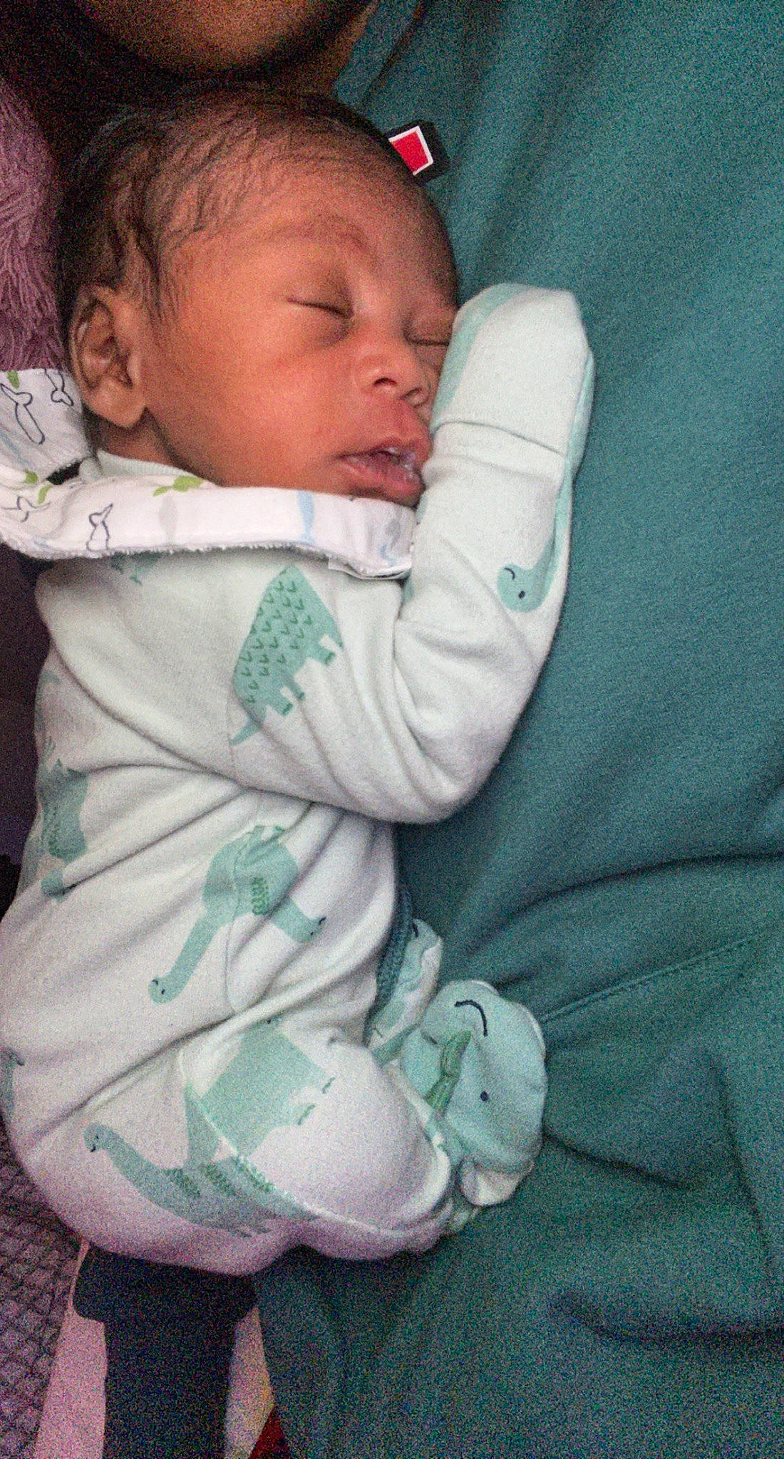 Kamari is registered to the contest to win money with this photo: baby, baby_products, baby_sleeping, baby_toddler_clothing, cheek, child, comfort, eye, face, finger, hand, happy, head, human_body, linens, mouth, nose, person, skin, sleeve