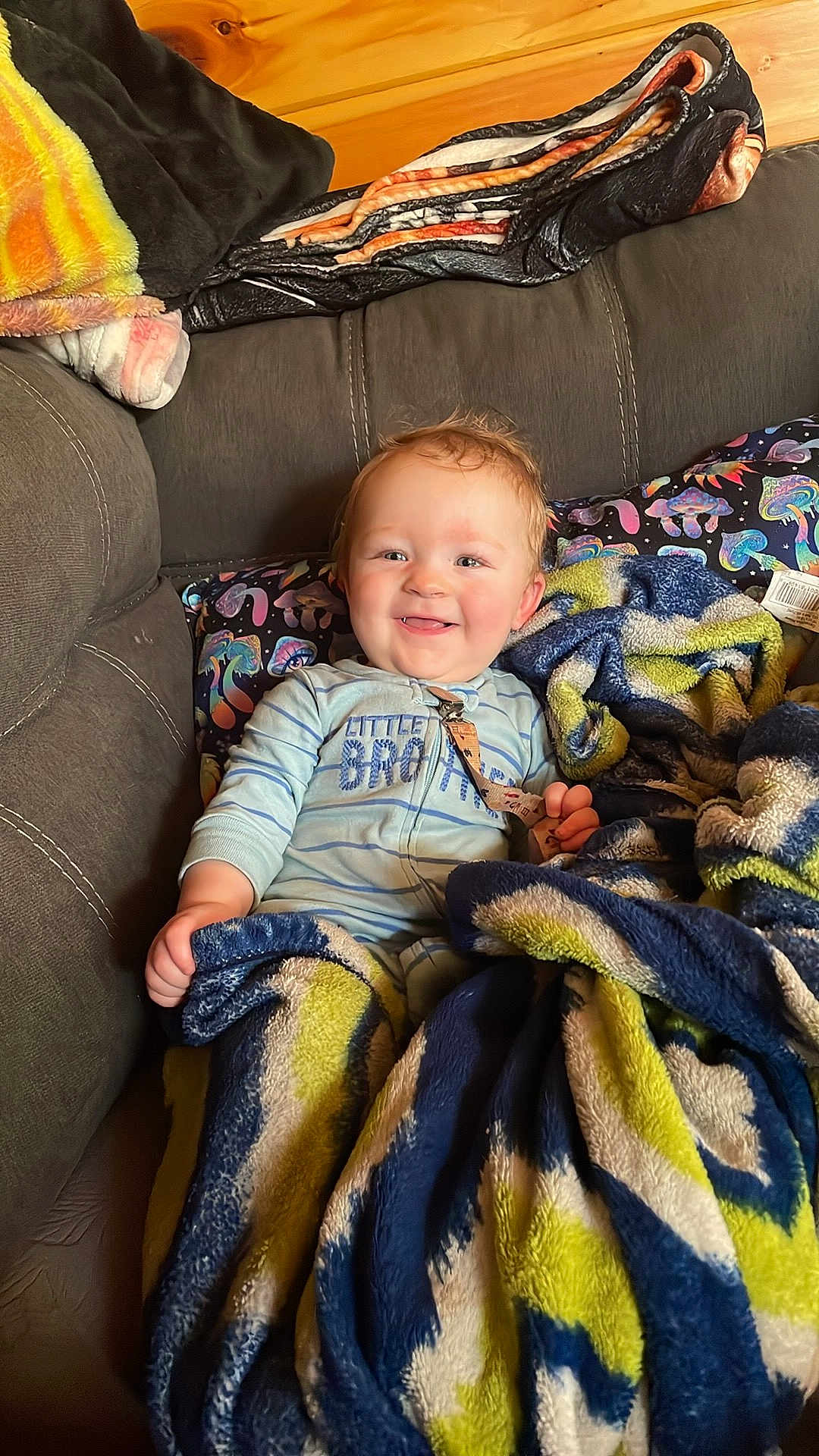 Hunter Lee joined the competition — help win amazing prizes! baby, child, smiling, blanket, couch, cozy, indoors, happy, person, portrait, comfort, warmth, colorful, soft, casual, clothing, furniture, relaxing, cute, young