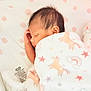 baby, sleeping, blanket, unicorn, stars, rainbow, bassinet, infant, soft, cozy, cute, child, peaceful, resting, pajamas, newborn, comfort, face, hand, hair