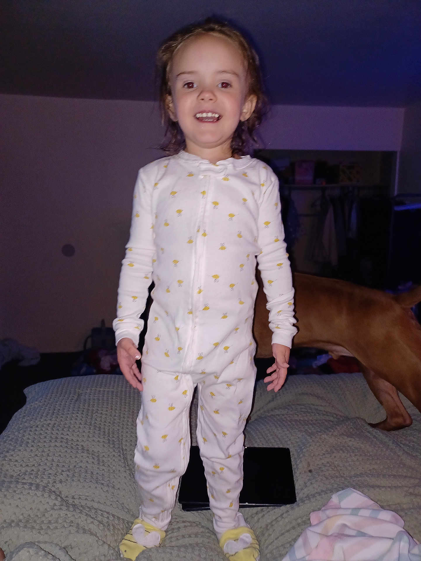 Oaklynn is registered to the contest to win money with this photo: child, toddler, pajamas, bed, blanket, smile, happy, indoor, person, dog, yellow, white, sleepwear, feet, face, standing, home, cozy, cute, hair