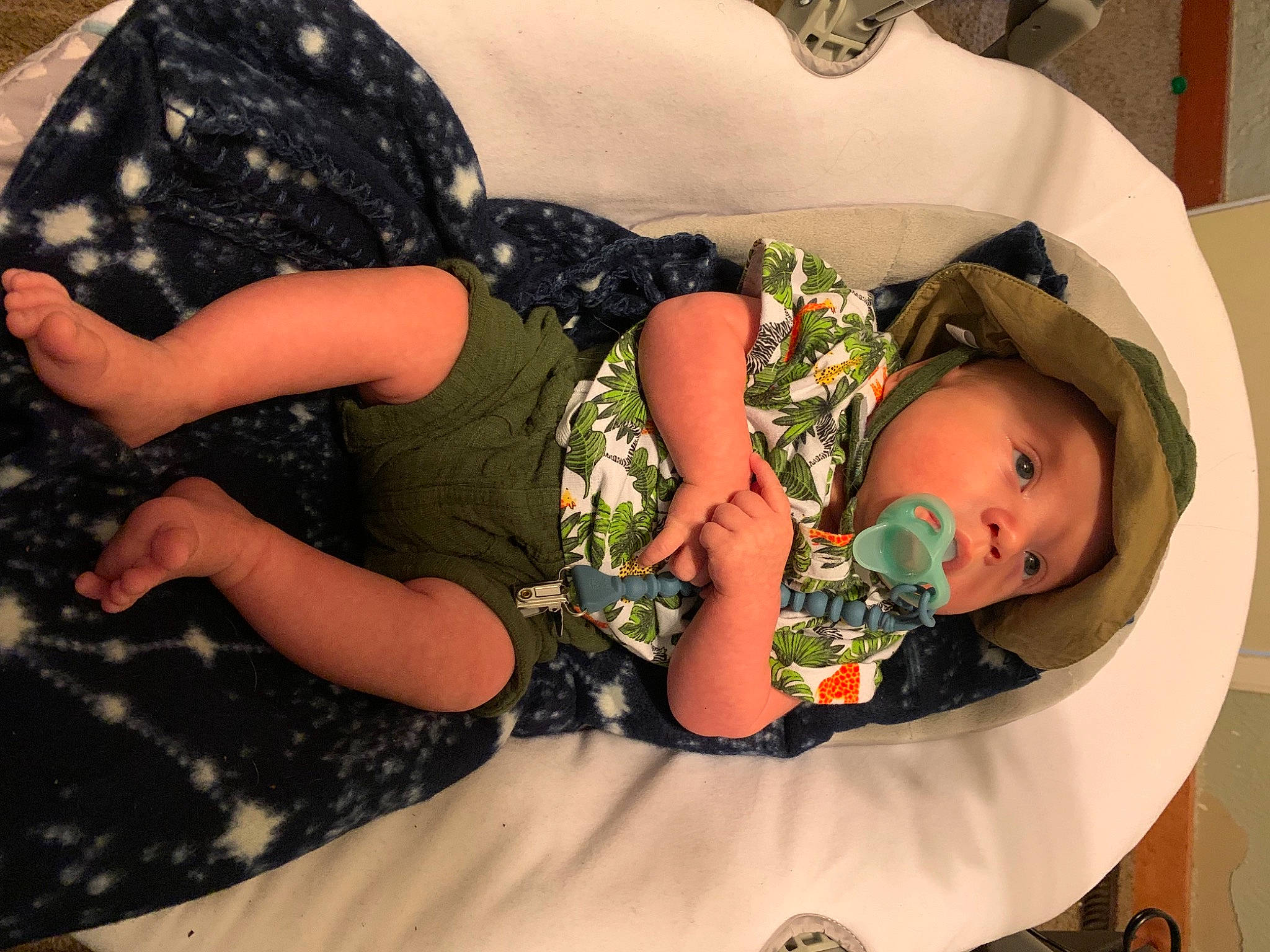 Kian joined the competition — help win amazing prizes! baby, baby_products, baby_toddler_clothing, child, comfort, fun, grass, hairstyle, hat, headgear, headwear, human_body, human_leg, leg, mouth, pattern, person, personal_protective_equipment, sitting, skin