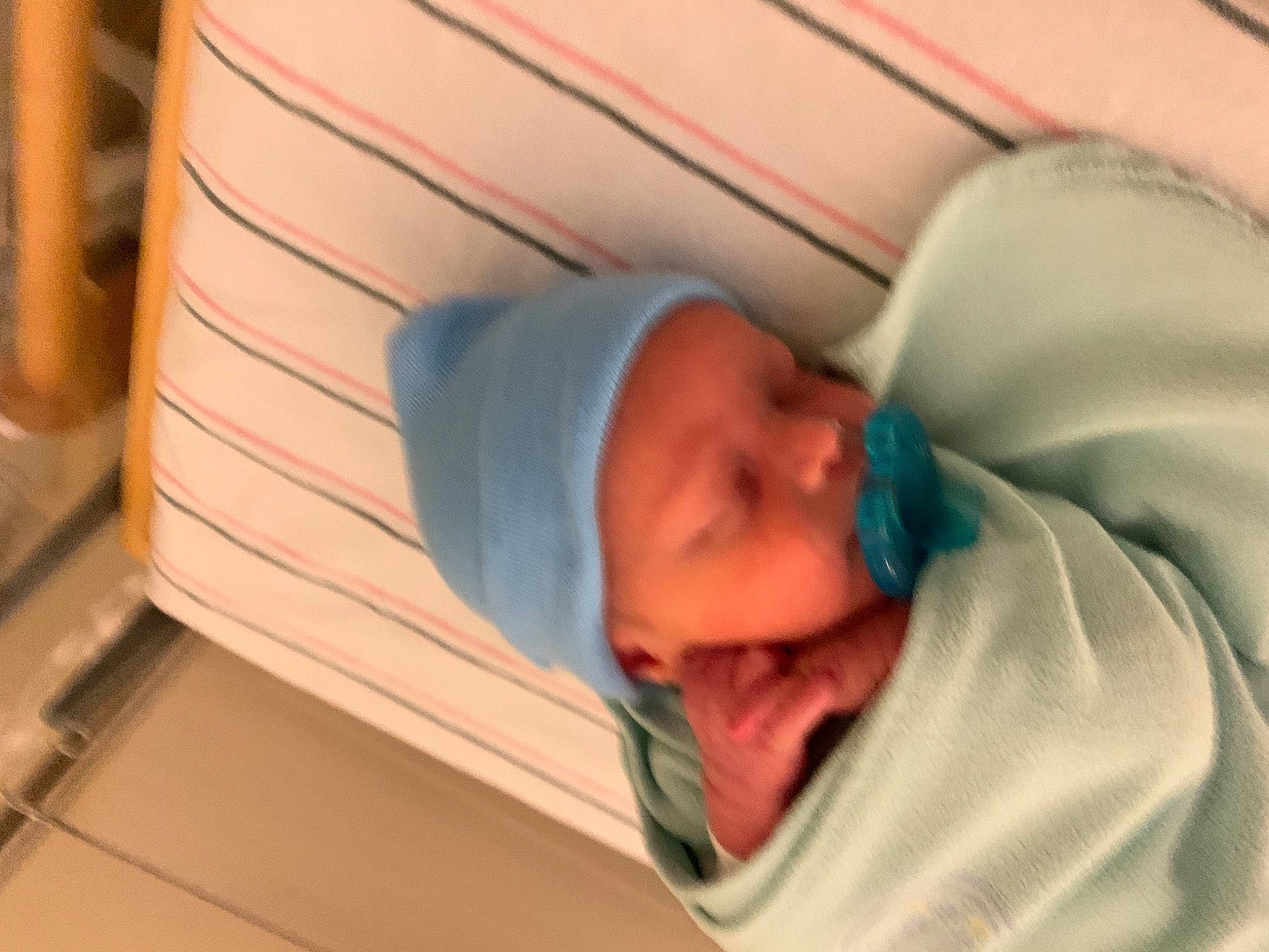 Kian is registered to the contest to win money with this photo: baby, baby_products, baby_safety, baby_sleeping, baby_toddler_clothing, bedtime, child, childbirth, comfort, headwear, hospital, medical, nap, person, room, service, sleep, toddler, wood