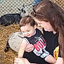 animal, baby, cattle, child, clothing, countryside, cow, face, female, girl, goat, head, livestock, nature, outdoors, person, pig, rabbit, straw, zoo