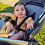 baby, city, clothing, face, furniture, grass, head, nature, outdoors, pants, park, person, photography, plant, portrait, road, sitting, street, stroller, urban