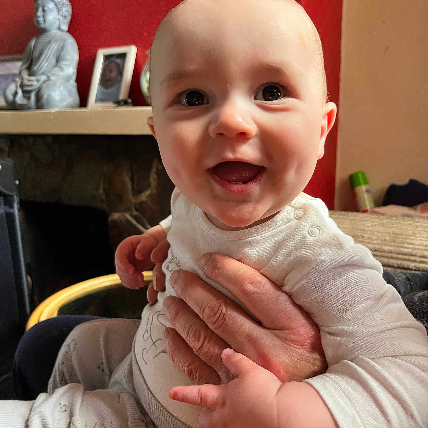 Theo is registered to the contest to win money with this photo: architecture, baby, babylaughing, bodypart, building, face, finger, fireplace, furniture, hand, happy, head, indoors, laughing, person, photoframe, photography, portrait, sitting, smile