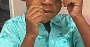 Zayne joined the competition — help win amazing prizes! child, boy, glasses, turquoise_shirt, indoor, curly_hair, playing, portrait, person, casual_clothing, hand, expression, young, cute, standing, light_skin, short_sleeve, home, fun, fashion