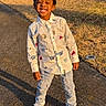 Zayne joined the competition — help win amazing prizes! child, boy, smiling, outdoor, sunlight, shirt, jeans, sneakers, sidewalk, grass, shadow, happy, casual_clothing, standing, daytime, playful, young, portrait, nature, tree_stump