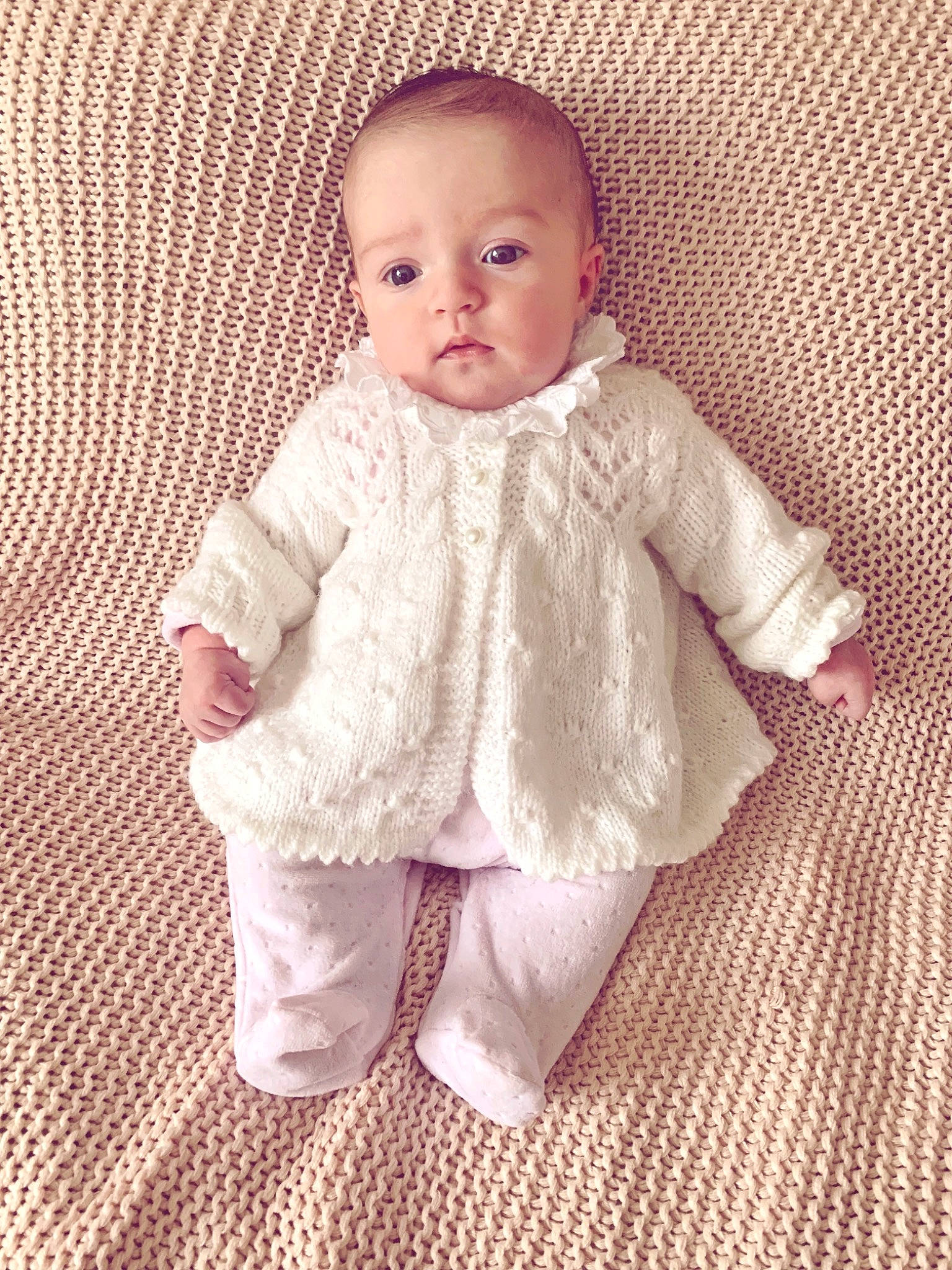 Darla is registered to the contest to win money with this photo: child, crochet, girl, infant, knitting, material, outerwear, pattern, person, pink, product, skin, smile, sweater, textile, toddler, wool