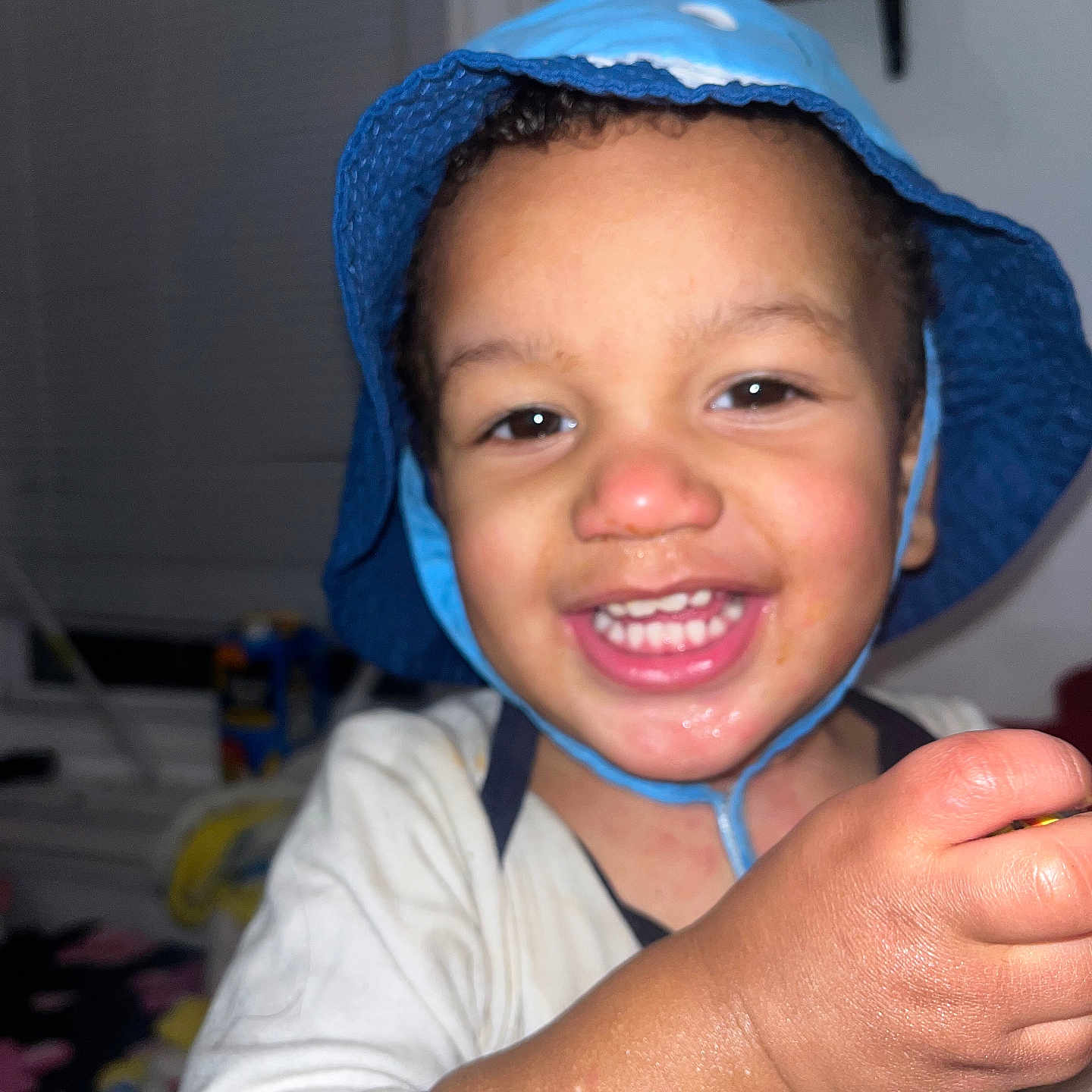 Azeem is registered to the contest to win money with this photo: baby, bodypart, bonnet, cap, clothing, face, finger, hand, happy, hat, head, hood, hoodie, mouth, person, photography, portrait, smile, sunhat, teeth