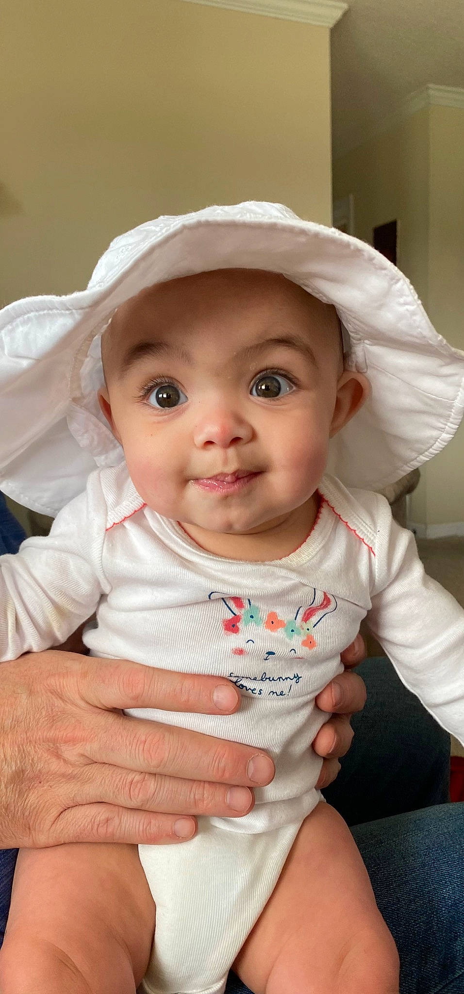 Alivia is registered to the contest to win money with this photo: baby, baby_toddler_clothing, cheek, chin, eye, face, facial_expression, hand, head, headwear, human, iris, lip, mouth, nose, organ, person, photograph, skin, sleeve