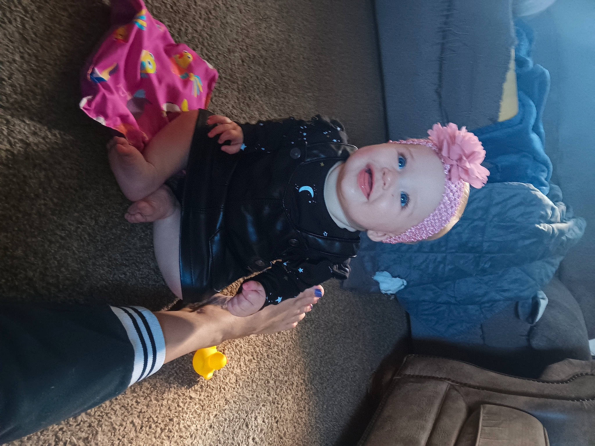 Alora is registered to the contest to win money with this photo: baby_products, baby_toddler_clothing, child, comfort, costume, fashion_accessory, fun, hat, lap, person, pink, purple, sitting, sock, toddler, tree, vacation, yellow