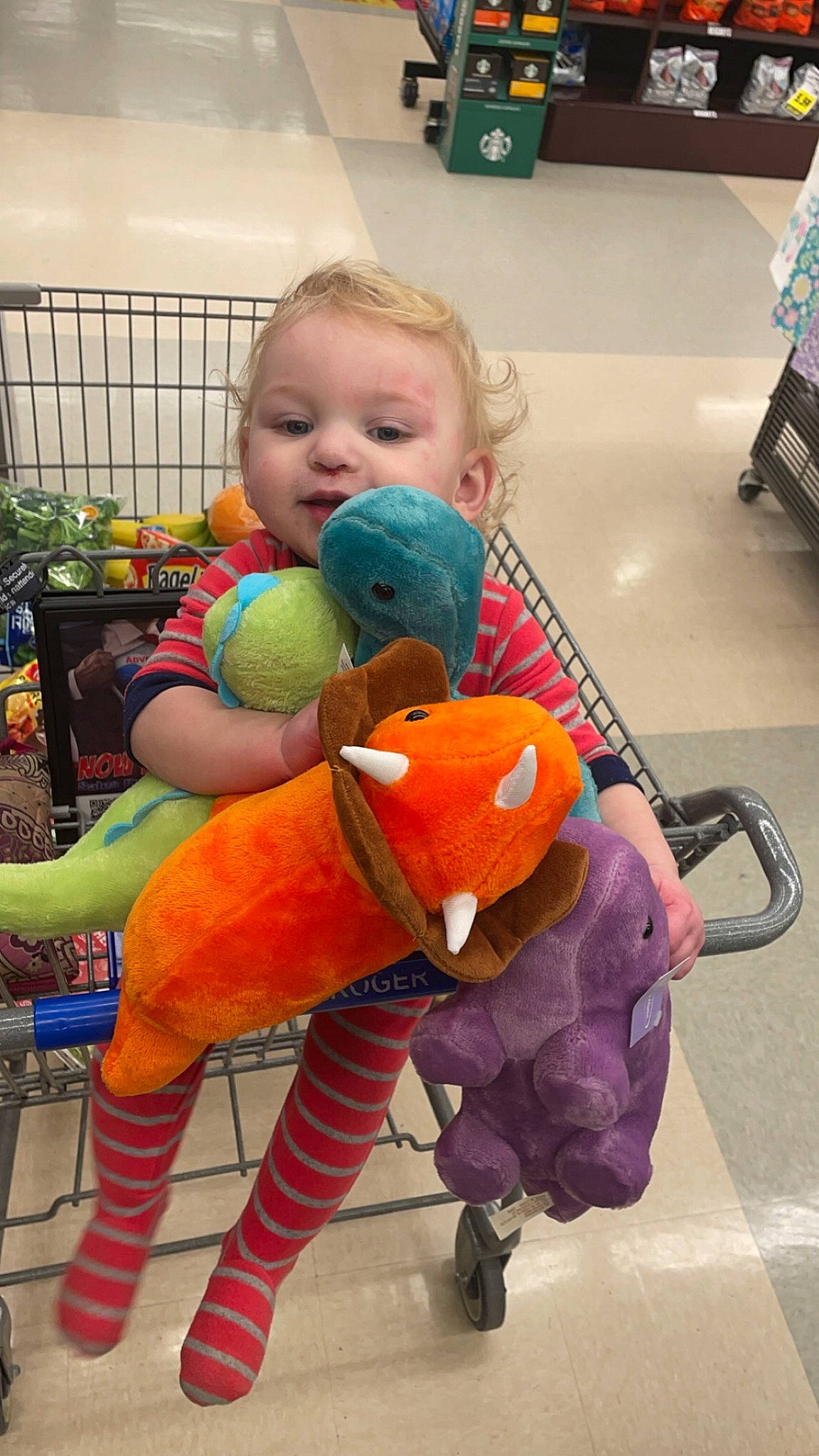 Malakai is registered to the contest to win money with this photo: baby, baby_products, baby_toddler_clothing, baby_toys, child, cleanliness, comfort, floor, flooring, fun, happy, leisure, person, play, plush, room, sitting, smile, stuffed_toy, toddler