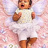 baby, infant, fairy_wings, pink_blanket, butterflies, smiling, tutu, headband, cute, happy, lying_down, child, soft_texture, celebration, newborn, three_months, playful, adorable, portrait, costume