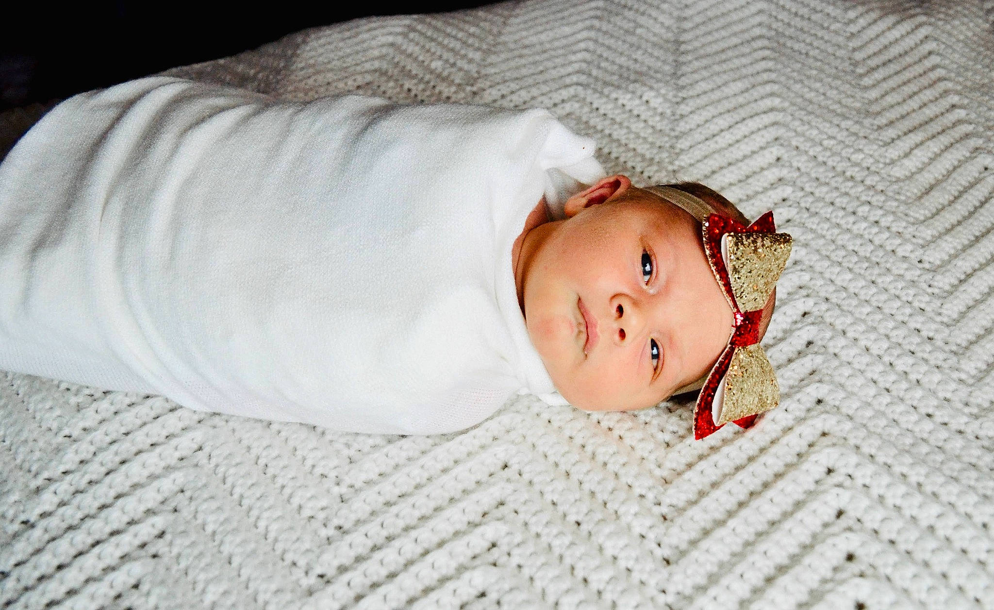 Emerie is registered to the contest to win money with this photo: baby, baby_toddler_clothing, bedding, bedtime, child, comfort, eye, eyelash, flooring, headgear, headwear, linens, nose, pattern, person, portrait_photography, room, skin, sleeve, textile