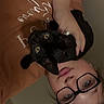Salem joined the competition — help win amazing prizes! cat, black_cat, pet, animal, person, woman, portrait, selfie, cuddling, indoors, glasses, eyewear, sweatshirt, human, face, whiskers, yellow_eyes, black_fur, home, upside_down