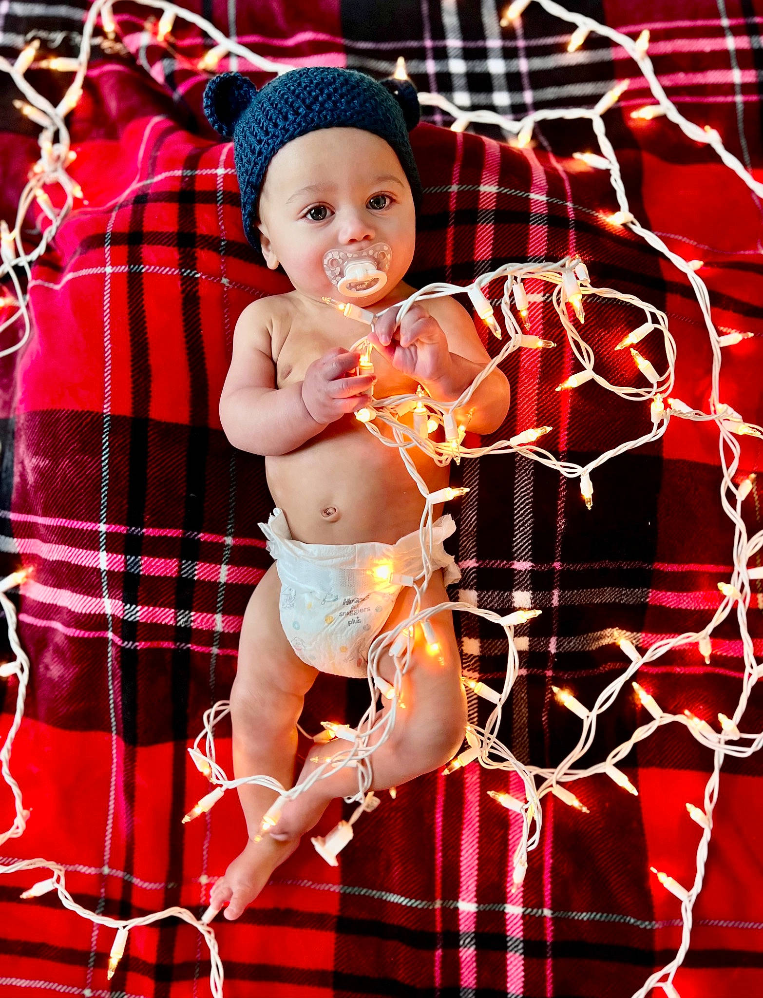 Caden joined the competition — help win amazing prizes! abdomen, baby, brassiere, chest, entertainment, event, happy, headwear, human_body, human_leg, muscle, navel, pattern, performing_arts, person, plaid, shorts, tartan, thigh, toddler