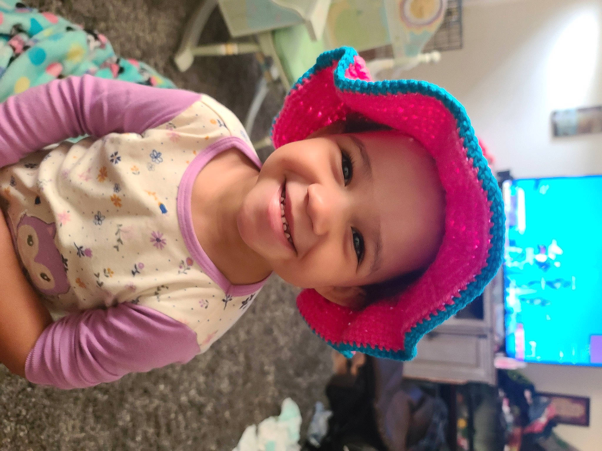 Syrenity is registered to the contest to win money with this photo: baby, cap, child, event, facial_expression, fashion_accessory, fun, happy, headgear, headwear, joy, leisure, lip, magenta, person, pink, plant, play, purple, skin