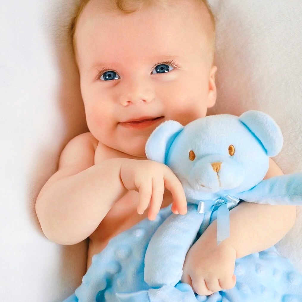 William is registered to the contest to win money with this photo: baby, bed, blanket, bodypart, cushion, face, finger, furniture, hand, happy, head, homedecor, laughing, newborn, person, photography, portrait, smile, teddybear, toy