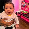 Azure joined the competition — help win amazing prizes! baby, child, tattoo, hand, pink_background, indoor, smiling, clothing, person, bench, poster, floor, bright, cute, holding, infant, sock, expression, happy, portrait