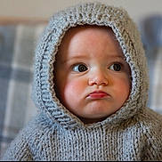 Remi is registered to the contest to win money with this photo: baby, beanie, bonnet, cap, clothing, face, fashion, happy, hat, head, hood, hoodie, knitwear, newborn, person, photography, portrait, smile, sweater, sweatshirt